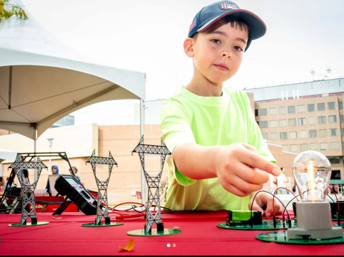 Student testing a battery storage and grid kit