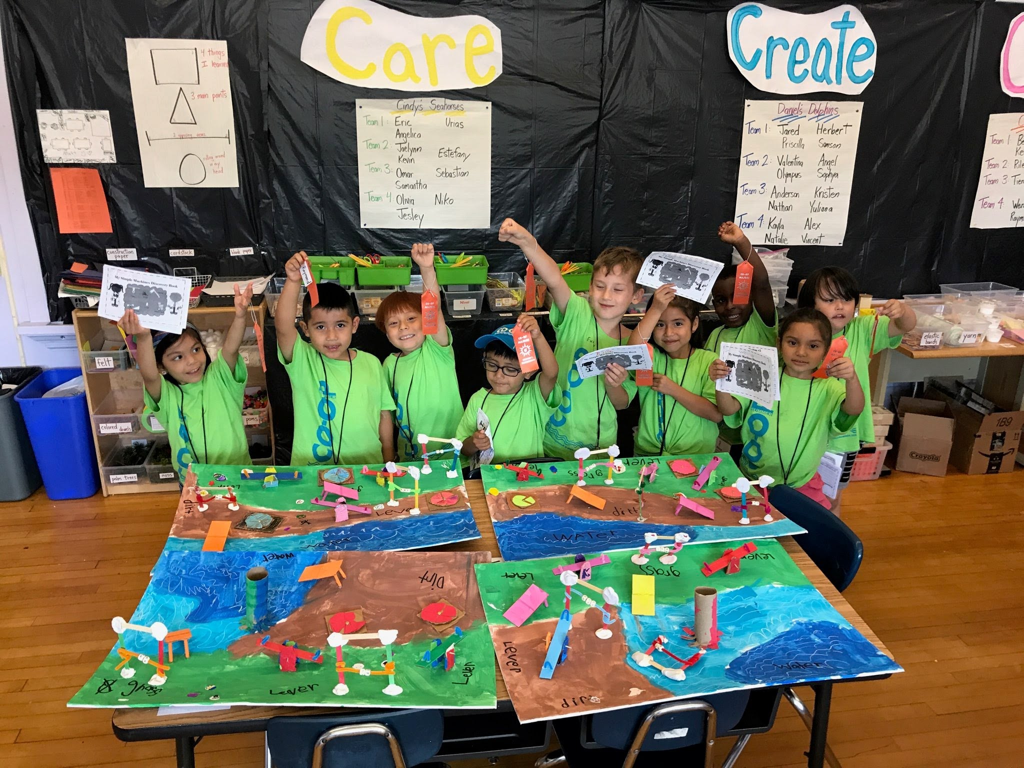Young students celebrating the simple machines they built