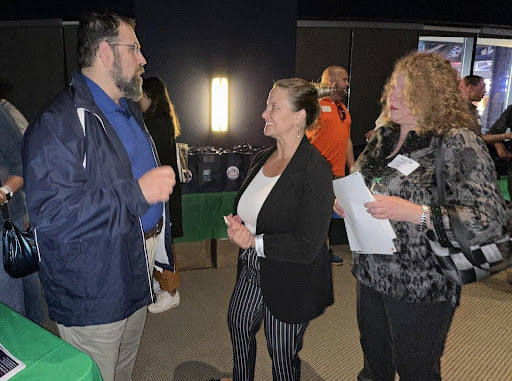 Company professionals connecting with local educators