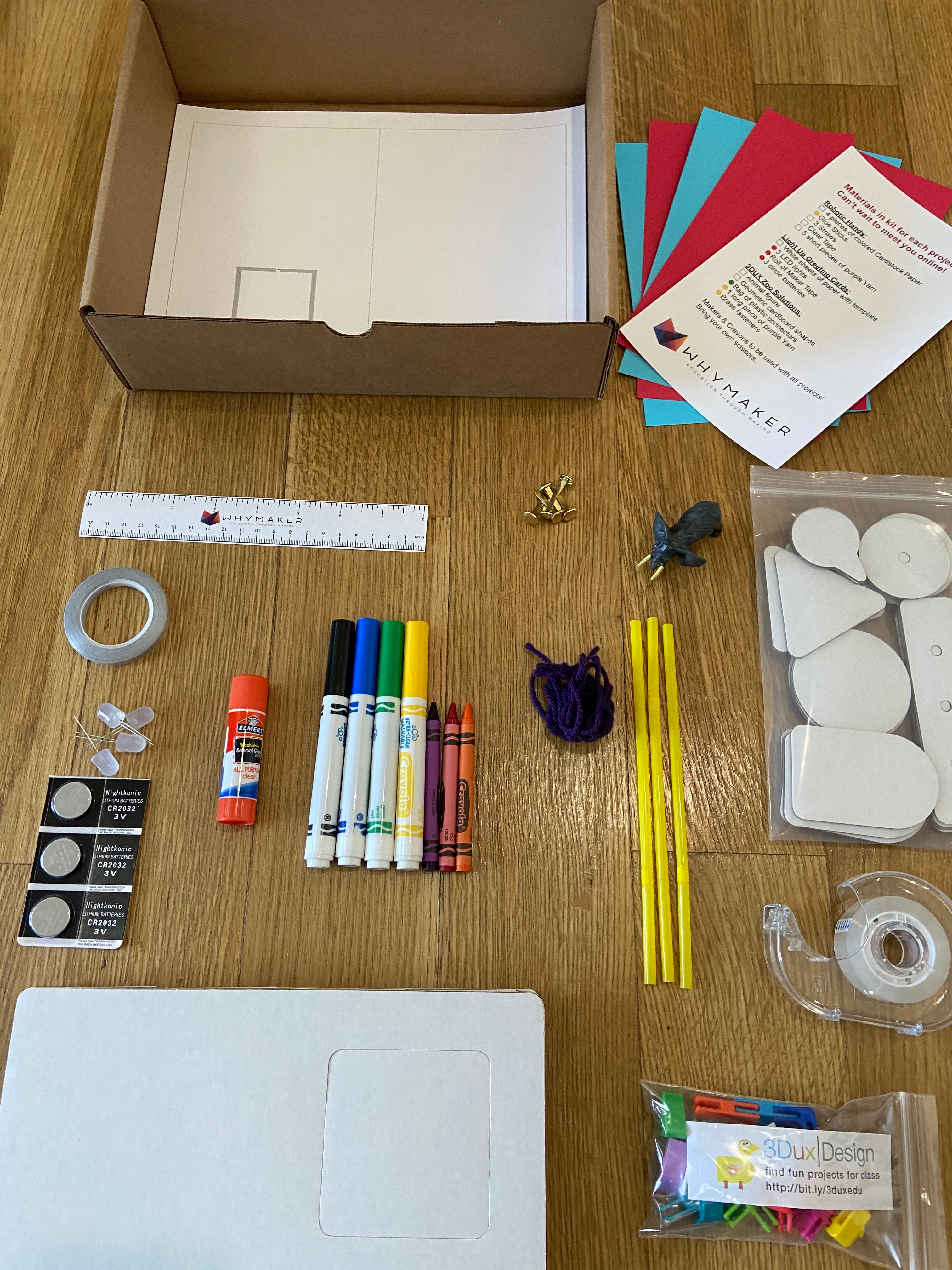 A branded WhyMaker activity kit laid out with all its materials