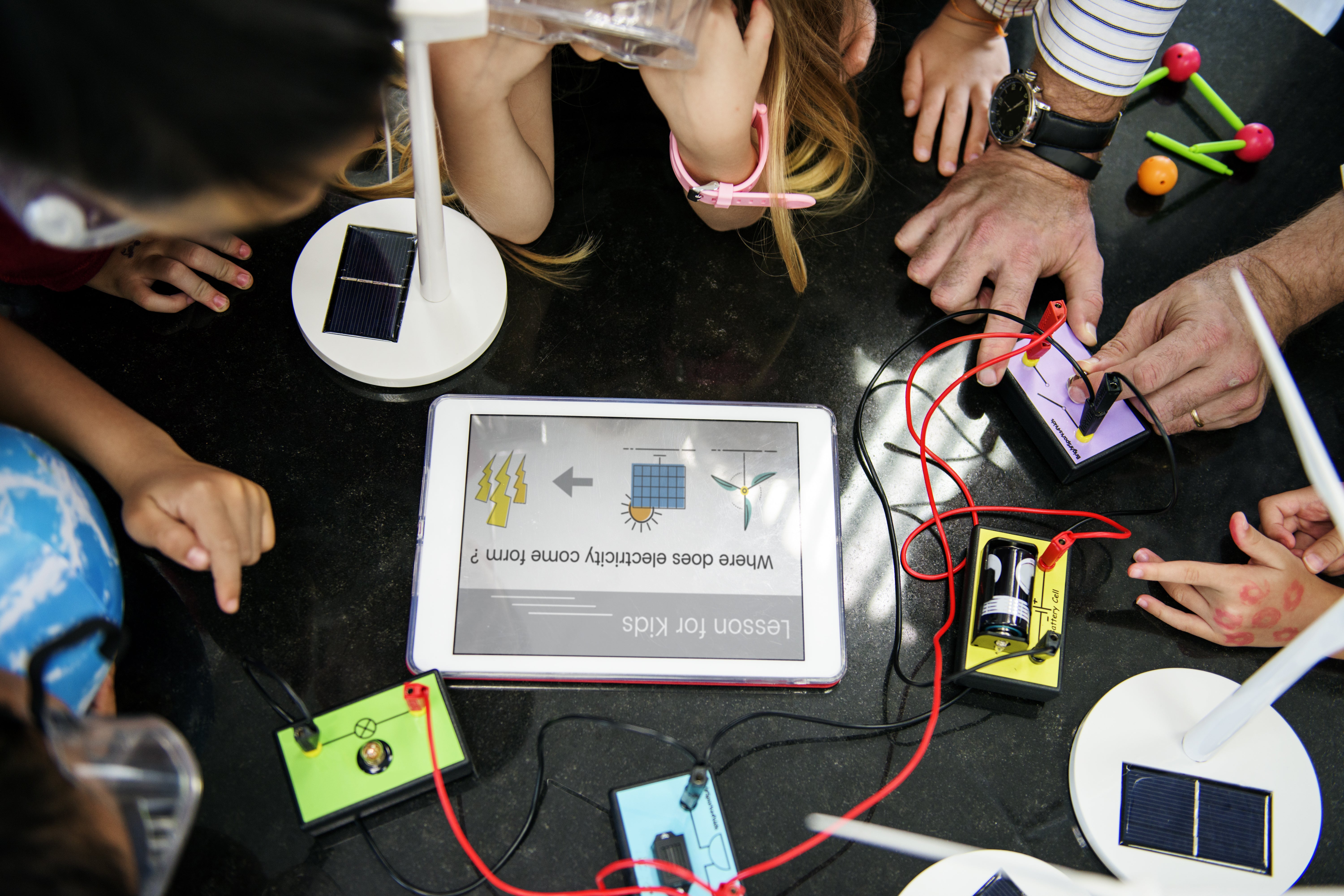 Students wiring solar panels and circuits in a lesson